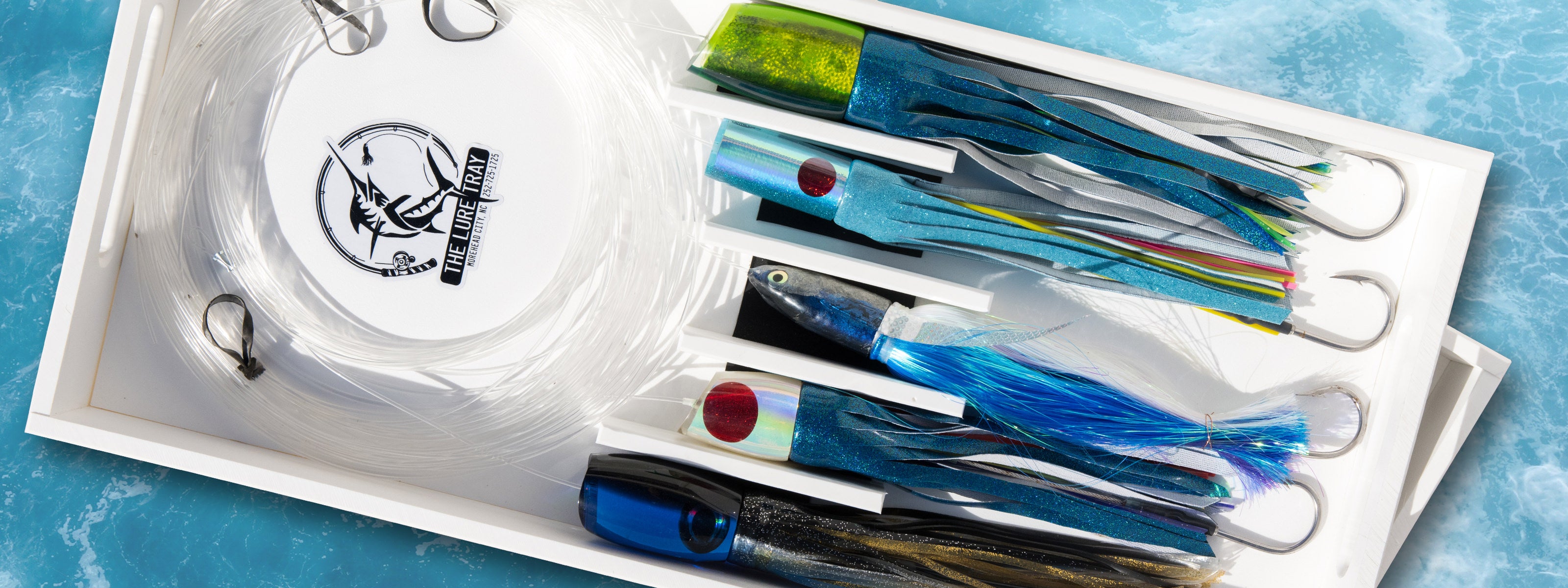 The Lure Tray lure box full of organized lures and a leader coil.